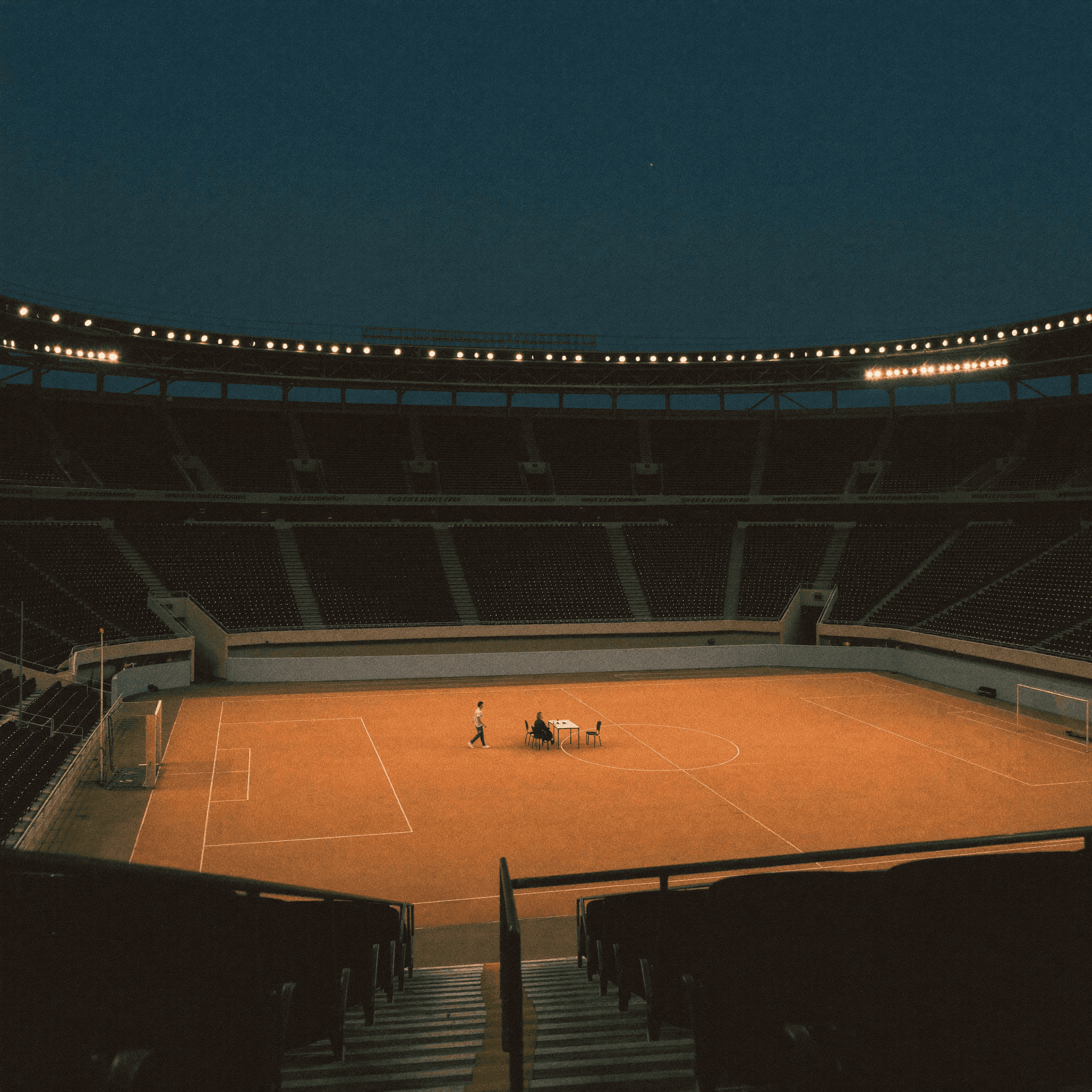 Manta brand illustration: two people meeting at a table in a floodlit stadium.